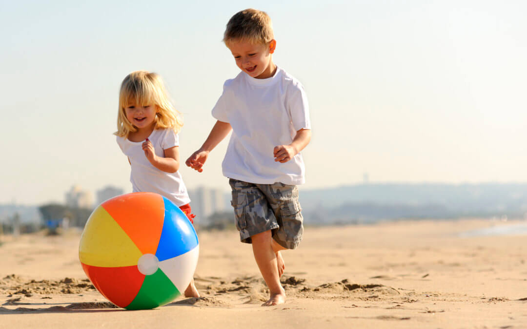 an image of children playing on the beach